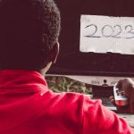 Gap Year - A man sitting in front of a computer with the word 2020 on it
