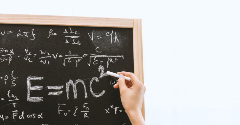 Equations - Person Holding a Chalk in Front of the Chalk Board