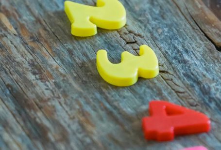 Math Puzzles - Multicolored numbers for counting on wooden table